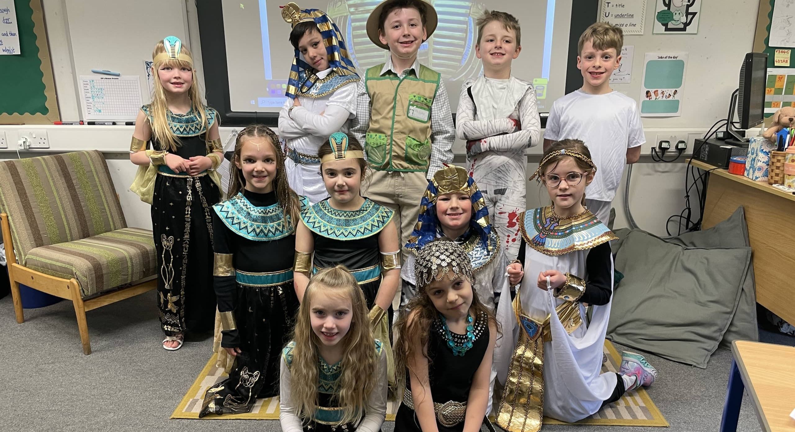 Ten pupils dressed in Egyptian costumes pose for a photo